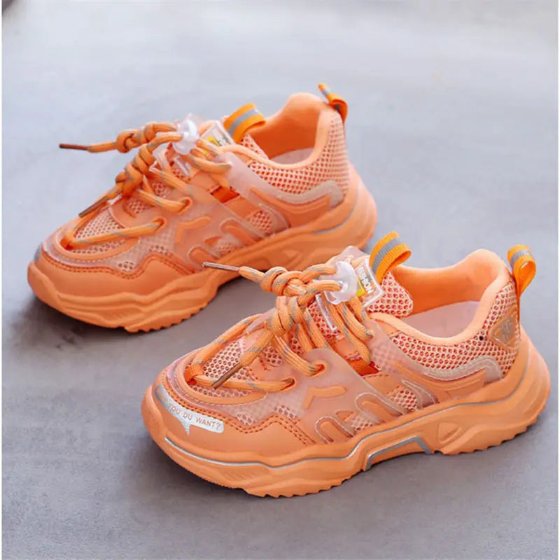 bright orange chunky sports shoes with mesh uppers and translucent overlays designed for older children casual wear