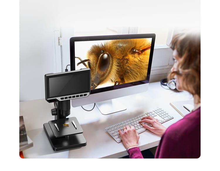black digital microscope royale essence lux with 7 inch hd touchscreen, adjustable focus knobs, and a stand shown alongside an imac displaying a magnified bee face image in the packing list context
