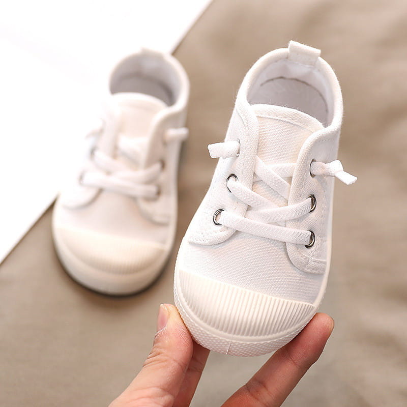 White canvas toddler sneaker with matching laces and ribbed rubber sole designed as colorful kindergarten indoor shoes with rubber soles suitable for indoor shoes baby and yards-inner length measurement.
