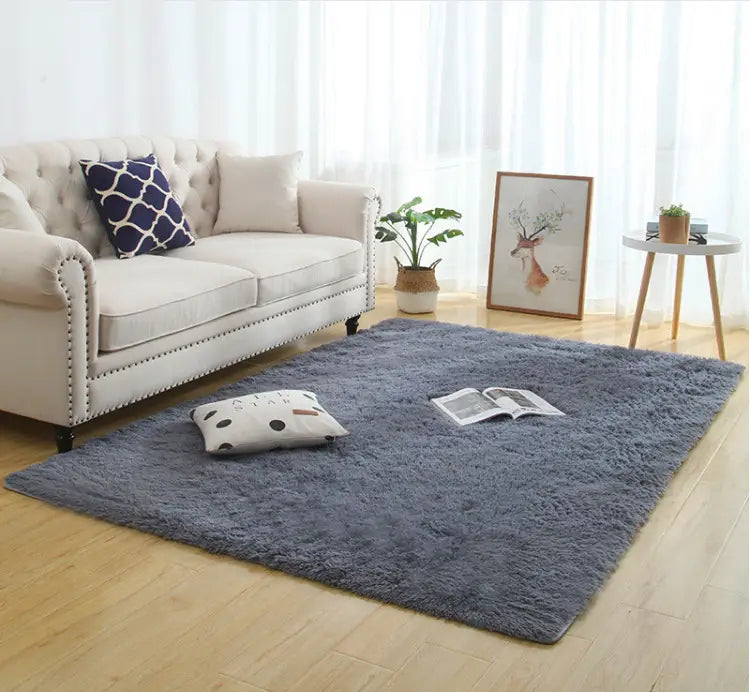 a plush deep gray silky fluffy carpet with a soft shaggy texture lies centered on a wooden floor showcasing a modern home decor style carpet modern home.