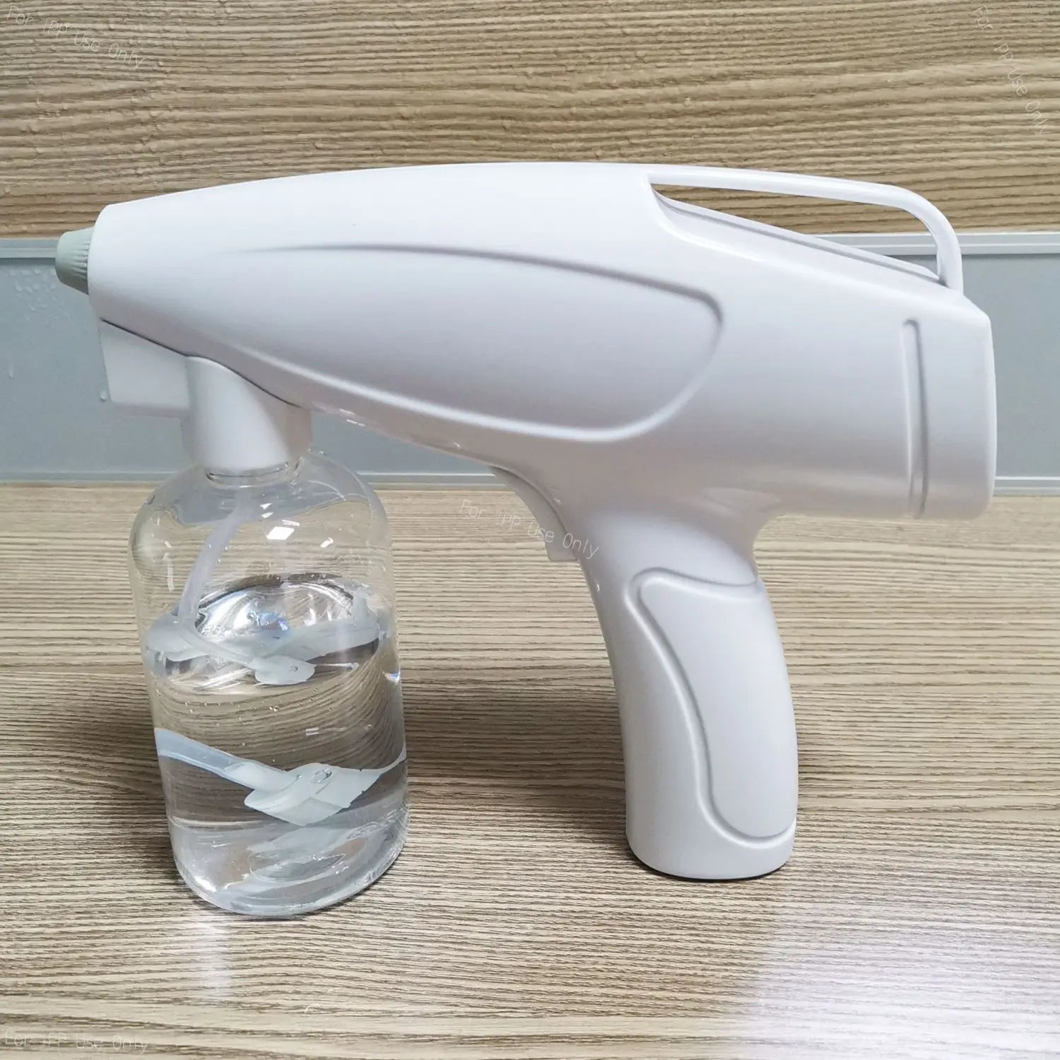 white plastic wireless electric sprayer disinfection gun with a clear glass bottle attached designed for easy grip and ergonomic use