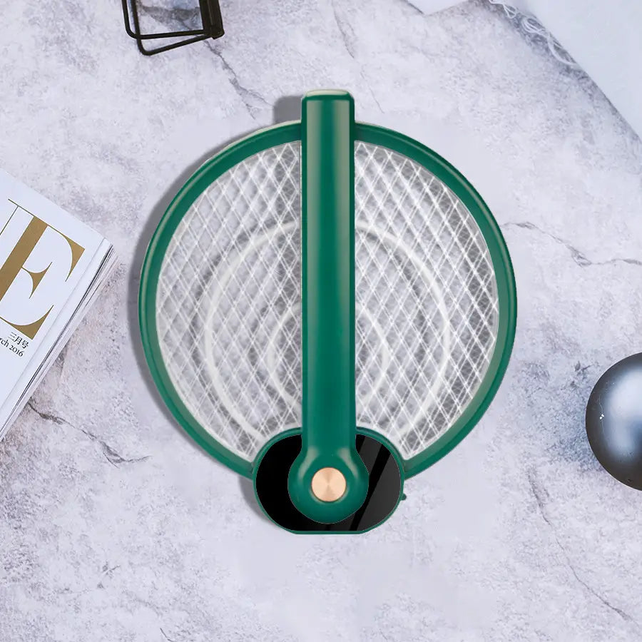 Green handheld electric mosquito swatter with circular mesh design and black base featuring mosquito trap mode for effective insect control.