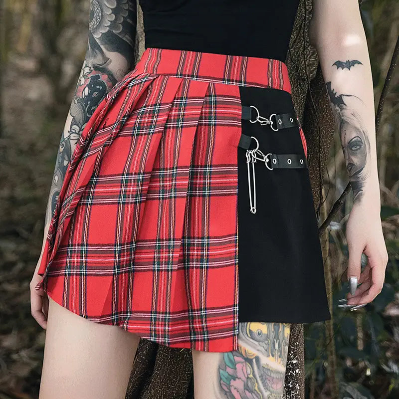 red and black plaid gothic pleated short skirt with a contrasting black panel featuring metal hardware and straps