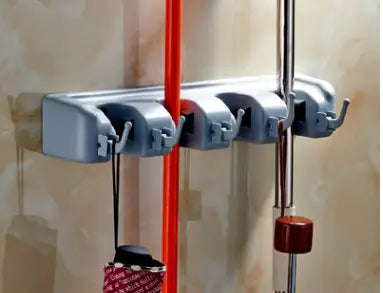 gray plastic mop hook wall hanging organizer rack with four slots and integrated hooks for toothbrushes and mops