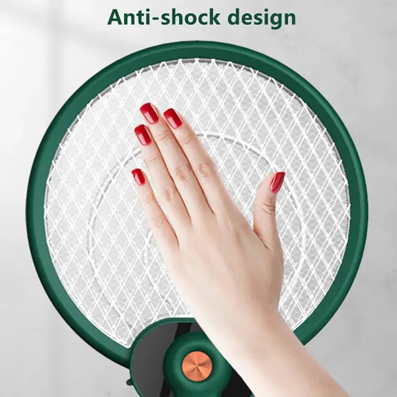 Green circular electric mosquito swatter with white mesh grid and anti-shock design featuring mosquito trap mode for effective insect control.