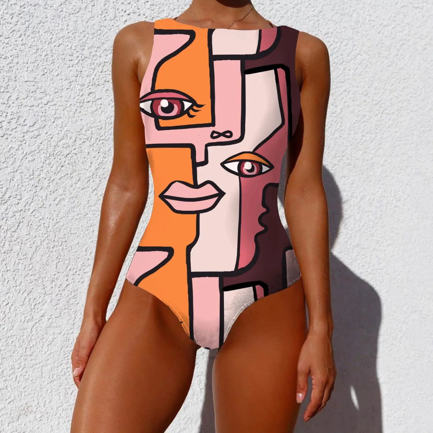 A sleeveless one-piece pop art vintage abstract print lady swimsuit featuring a bold abstract face design in vibrant orange pink and mauve tones with black outlines.