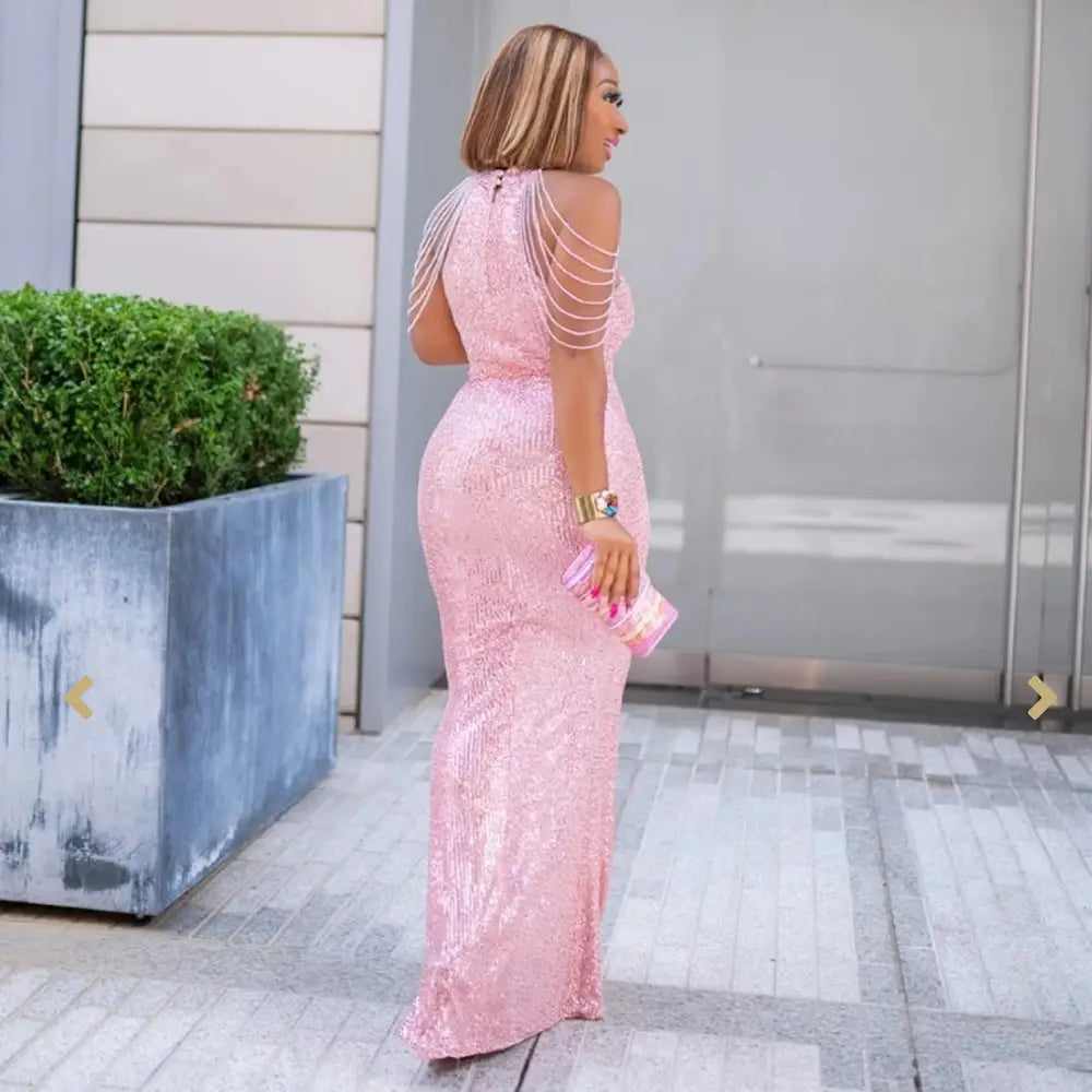 a shimmering pink sequined african ladies quality high stretch dress with delicate shoulder straps and a fitted silhouette