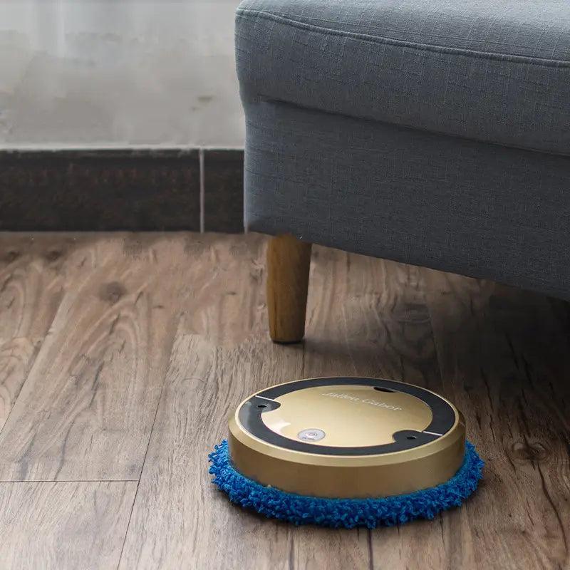 Silver white intelligent automatic sweeping robot with a gold-colored circular floor cleaner and blue microfiber cleaning pad for efficient intelligent automatic sweeping.