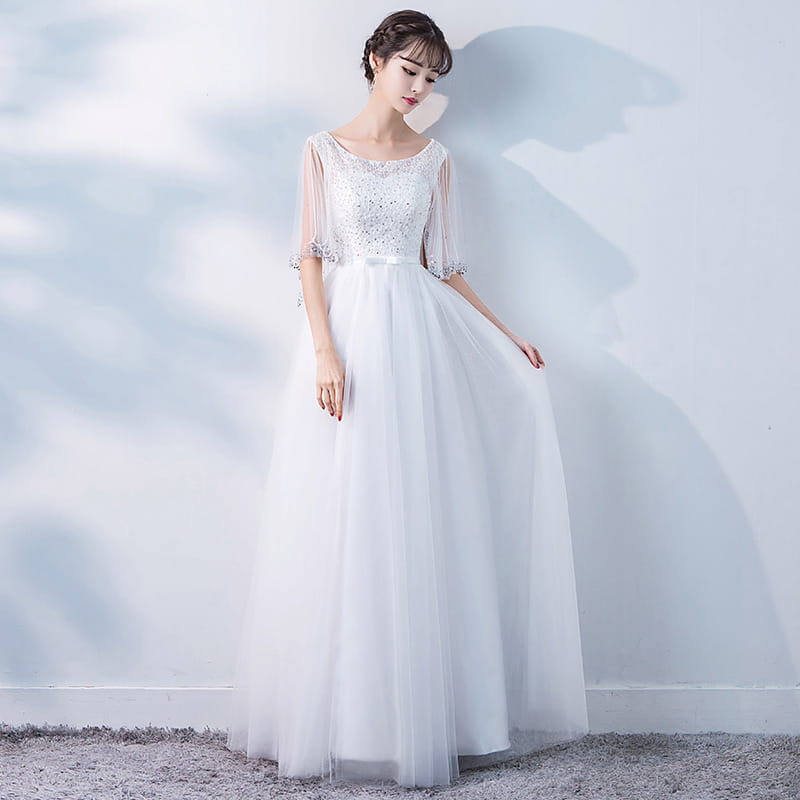 a white banquet evening dress female featuring a beaded bodice, sheer three-quarter sleeves, and a flowing tulle skirt ideal for spring events