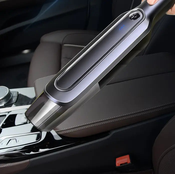 A sleek gray and black cordless handheld vacuum cleaner with a silver-gray modern design and blue led indicator light on the suction head.