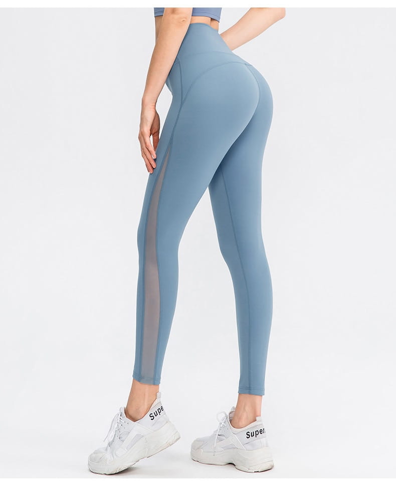Light blue women seamless high waisted yoga pants featuring sheer side panels designed as butt lifting workout leggings.
