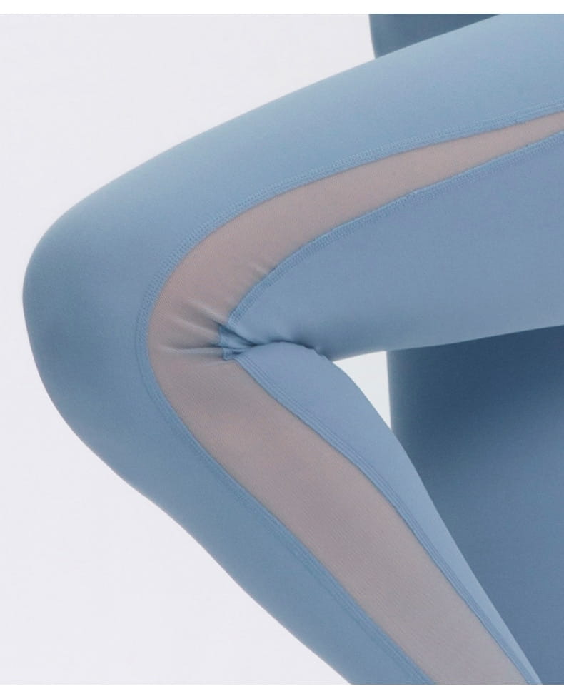 Light blue women seamless high waisted yoga pants with a sheer panel along the side designed as butt lifting workout leggings.