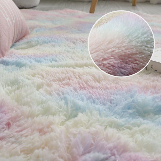 A gray shaggy living room plush rug with pastel pink, blue, and white soft striped fluffy texture ideal as a room plush rug.