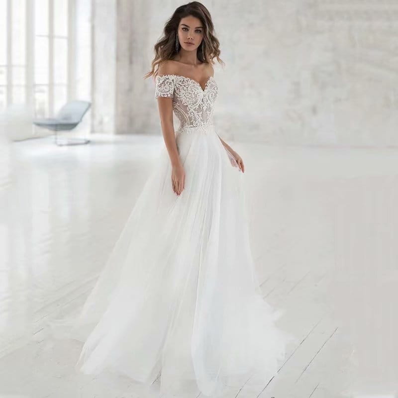 Elegant lace light wedding dress featuring a white off-the-shoulder wedding dress design with intricate lace detailing on the bodice and short sleeves paired with a flowing tulle skirt.