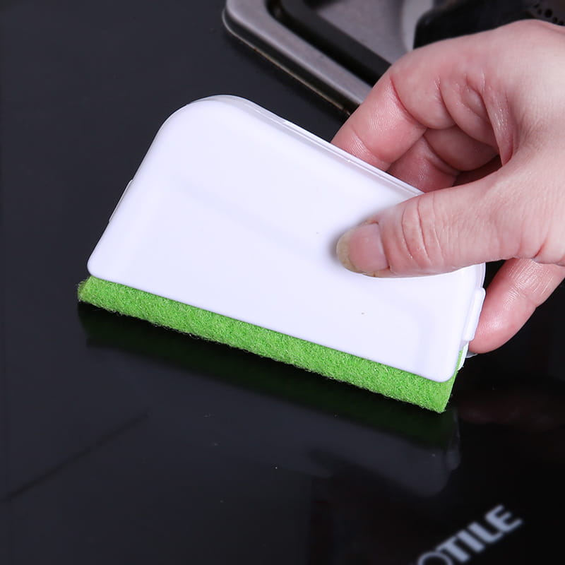 Gap brush with a white and green dual-sided sponge scrubber and plastic handle designed for cleaning window grooves and smooth surfaces.