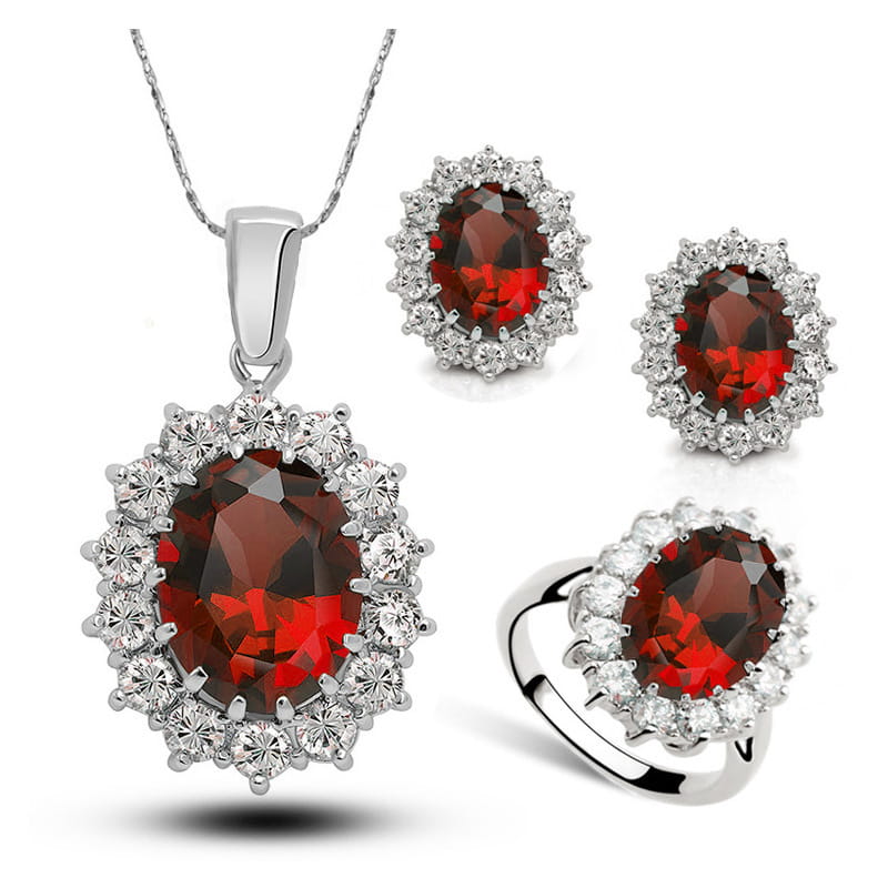 elegant garnet and diamond jewelry bridal necklace earrings and ring set featuring oval-cut red gemstones surrounded by sparkling clear stones in silver-toned metal