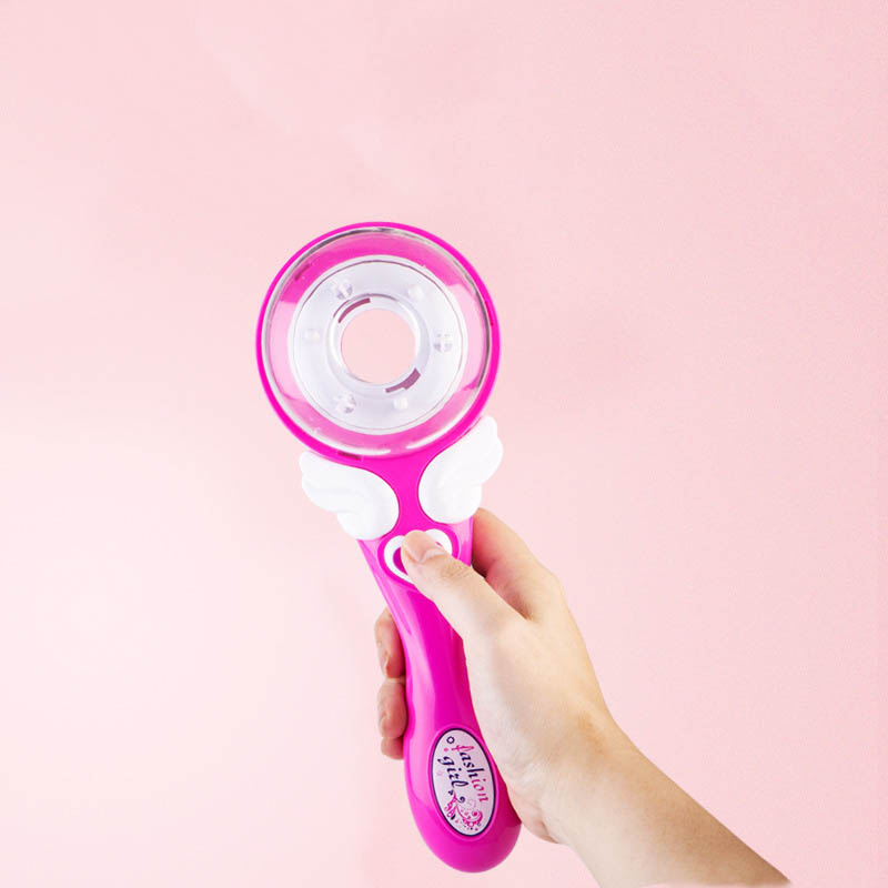 A bright pink girls electric automatic hair brush with a clear circular head and white wing-like accents designed for automatic hair braid fashion use.