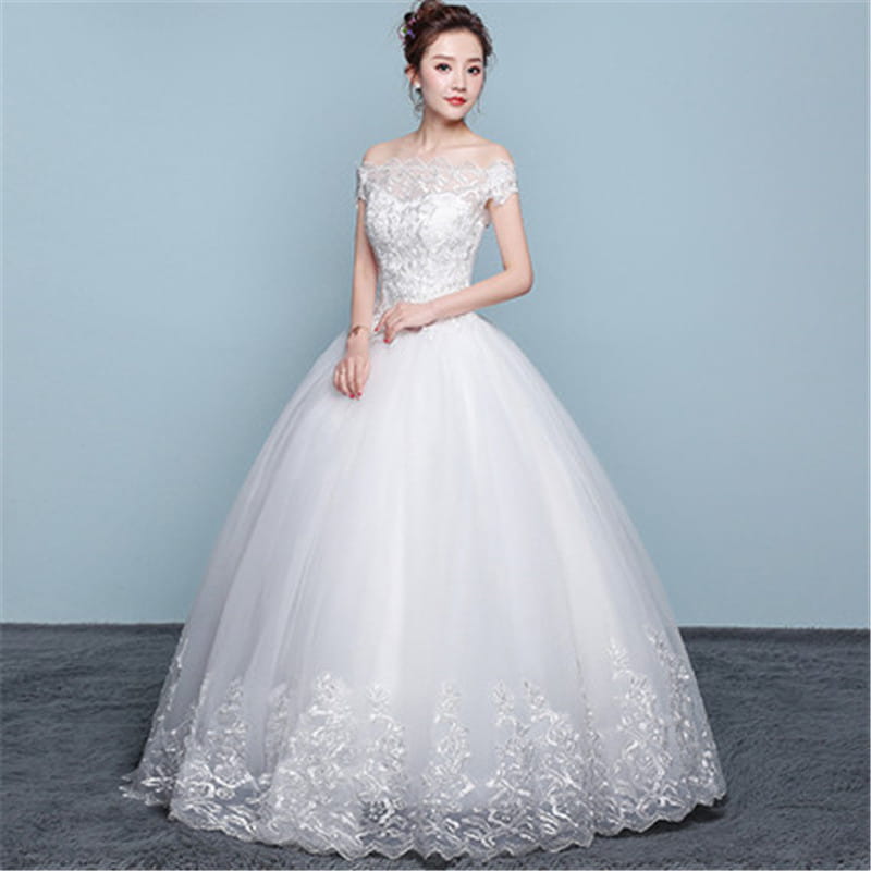 white off-the-shoulder wedding dress featuring intricate lace detailing and a voluminous tulle skirt designed as a lace and beaded floor length wedding dress