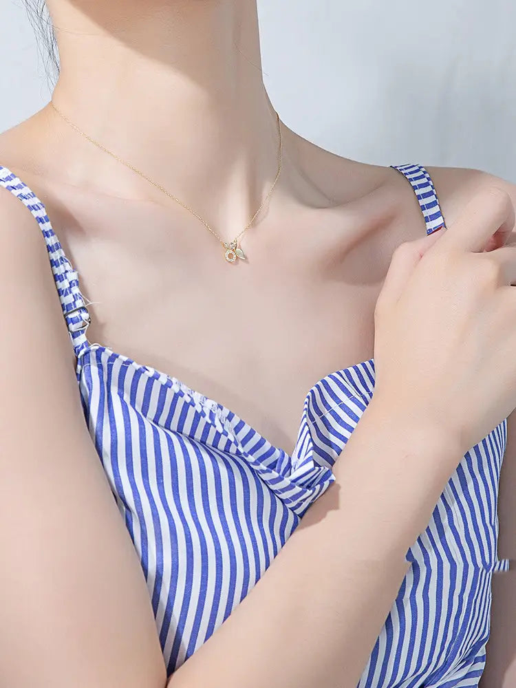 A delicate 18k gold plated necklace featuring a small intricate bee pendant alongside a gold plated rabbit pendant with carrot.