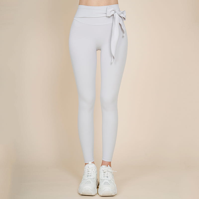 Light gray korean fashion high waisted yoga pants with a tied bow at the waist suitable for nude sports yoga.