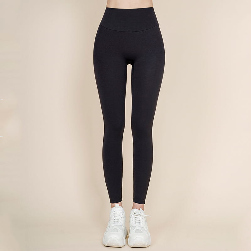 Black Korean fashion high waisted bow yoga pants made of smooth stretchy fabric ideal for nude sports yoga and casual wear.