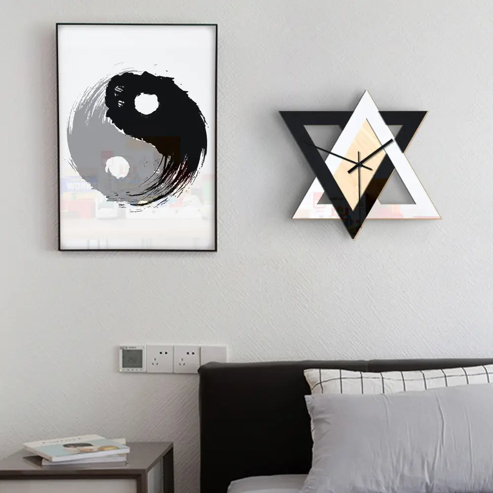 Modern geometric wall clock featuring a nordic personality black and white creative wall design with beige triangular patterns.