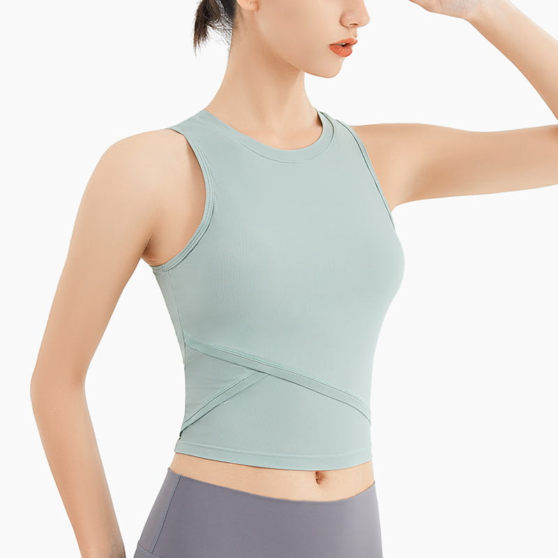A light mint green ribbed sleeveless fitness vest with chest pad featuring a round neckline and diagonal cross-over paneling.