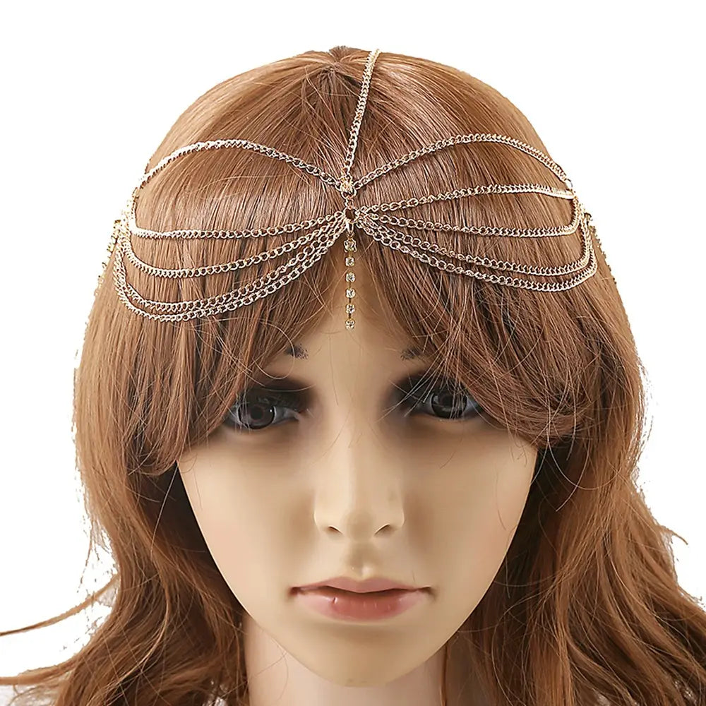 Gold-toned multi layer head chain featuring delicate links and a central tassel inlaid diamond decorative element for elegant hair adornment.