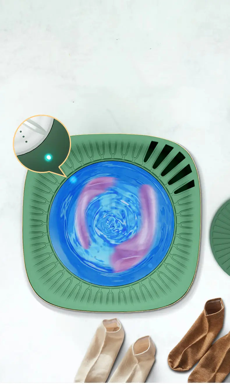 Teal mini portable washing machine with a green square-shaped laundry sorter featuring a blue swirling water effect and black ventilation slits on its sides.