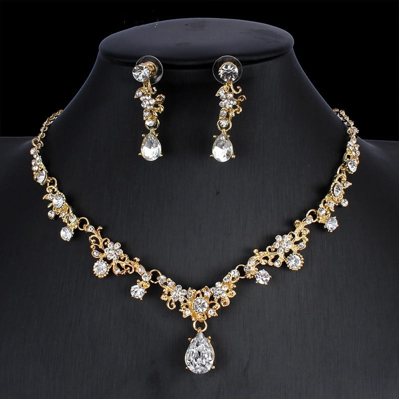 Golden zircon jewelry set featuring a gold-toned bridal floral necklace with intricate designs and clear sparkling crystals, complemented by matching drop earrings with teardrop-shaped stones.