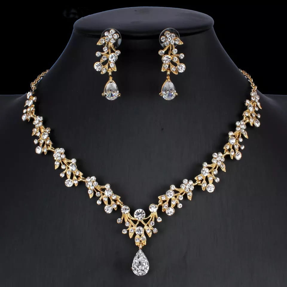 gold-toned golden zircon jewelry set bridal featuring intricate leaf and crystal designs with a central teardrop pendant.