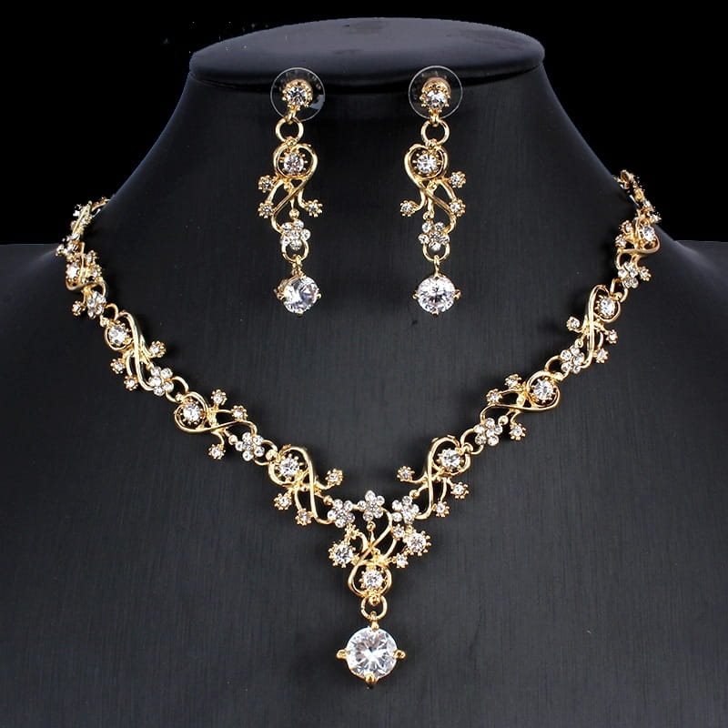Golden zircon jewelry set featuring a gold-toned bridal floral necklace with intricate designs and sparkling clear crystals, paired with matching drop earrings.