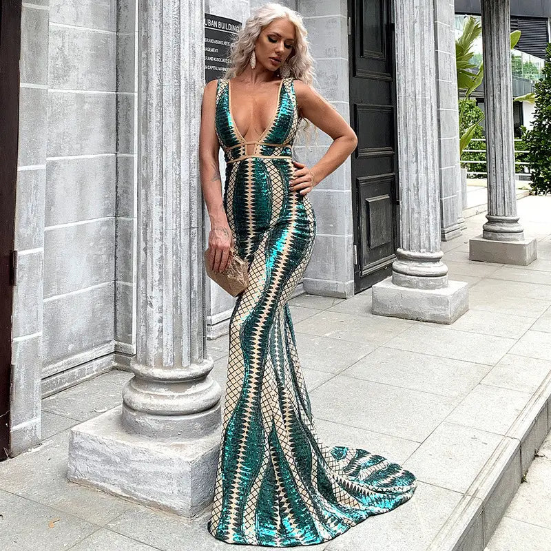 A shimmering emerald and cream sequined mermaid evening dress with a plunging neckline made of polyester fiber main fabric.