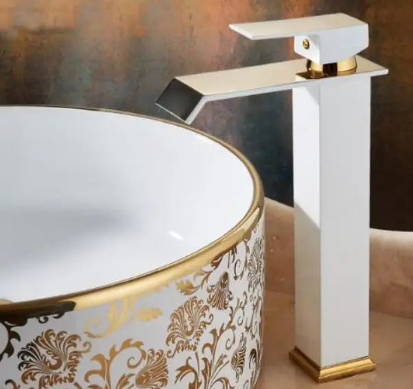 White and gold cold water waterfall basin faucet with a sleek rectangular spout and handle designed for modern bathroom use.