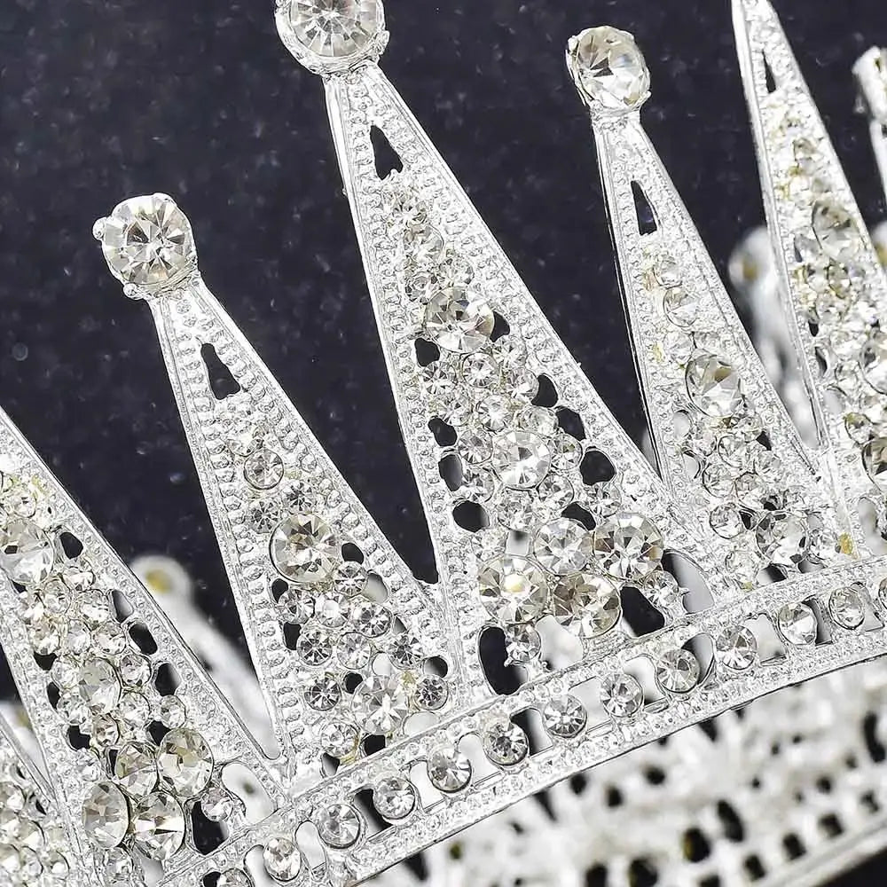 a sparkling silver alloy crown adorned with numerous clear rhinestones and intricate cut-out designs perfect for fashion bridal hair and bridal hair accessories.