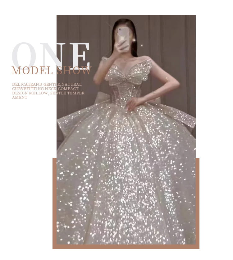 A shimmering silver sequined one-shoulder wedding dress with a fitted bodice and a long trailing heavy industry skirt.