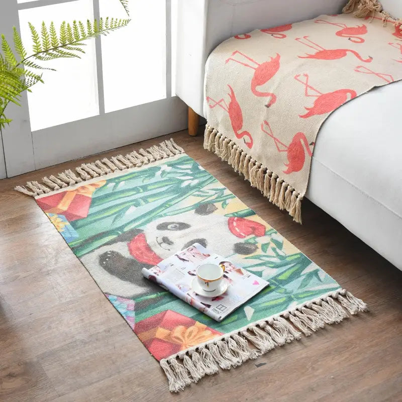 Colorful rectangular scandinavian style linen cotton rug with panda design surrounded by bamboo and gift boxes featuring beige fringed edges.