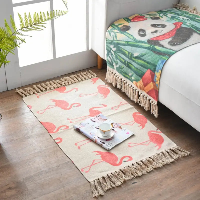 Beige scandinavian style linen cotton rug with a pink flamingo pattern and natural fiber tassel fringe.