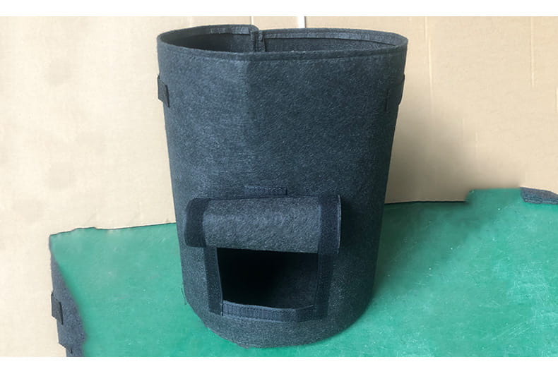 dark gray felt cylindrical planting bag potato with a rectangular entrance and reinforced fabric flaps designed for potato planting