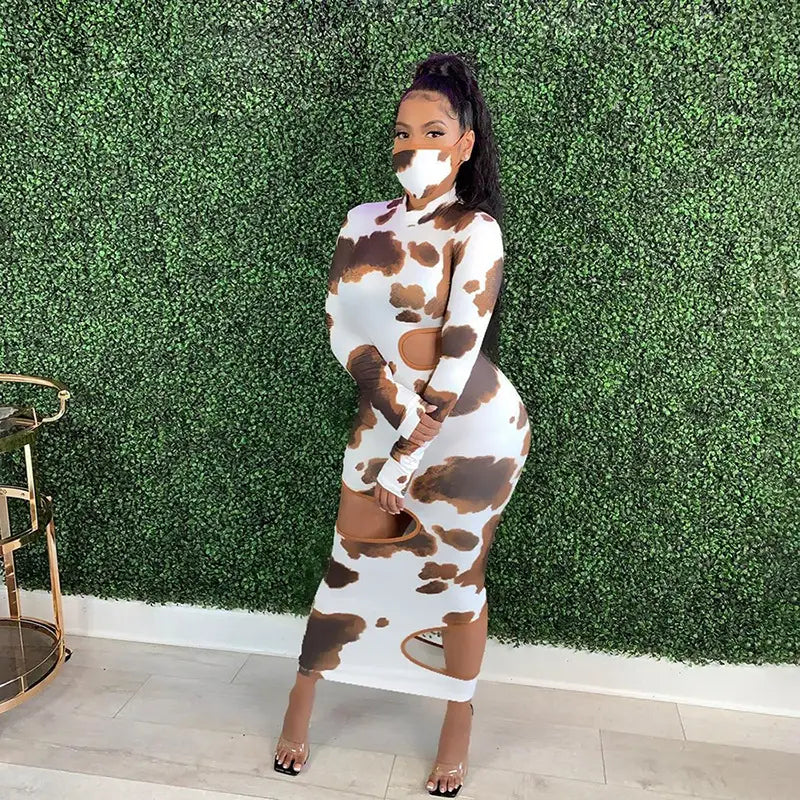 A form-fitting women irregular hole maxi dress in white and brown cow print with long sleeves and weird puss hollow cut-out details.
