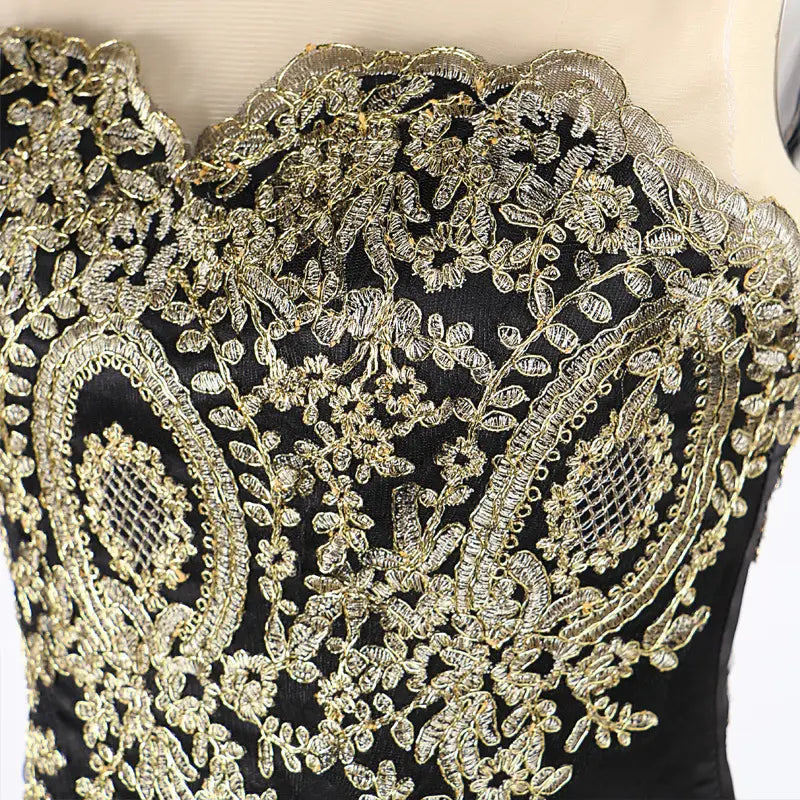 black satin corset top with intricate gold lace embroidery featuring floral and paisley patterns, complementing the red mermaid bride toast gown with gold beading, designed for font-style normal text-decoration and general vertical-align middle presentation.