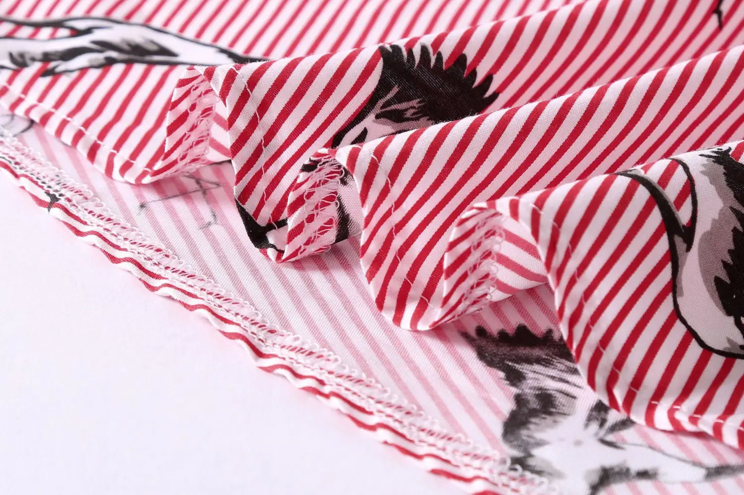 long sleeve women’s striped shirt dress featuring red and white striped fabric with black and white animal illustrations and a ruffled hemline