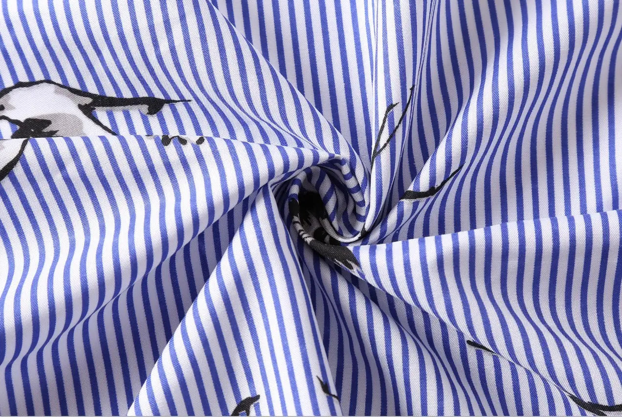 Long sleeve striped shirt dress in blue and white cotton fabric featuring a subtle black bird pattern.