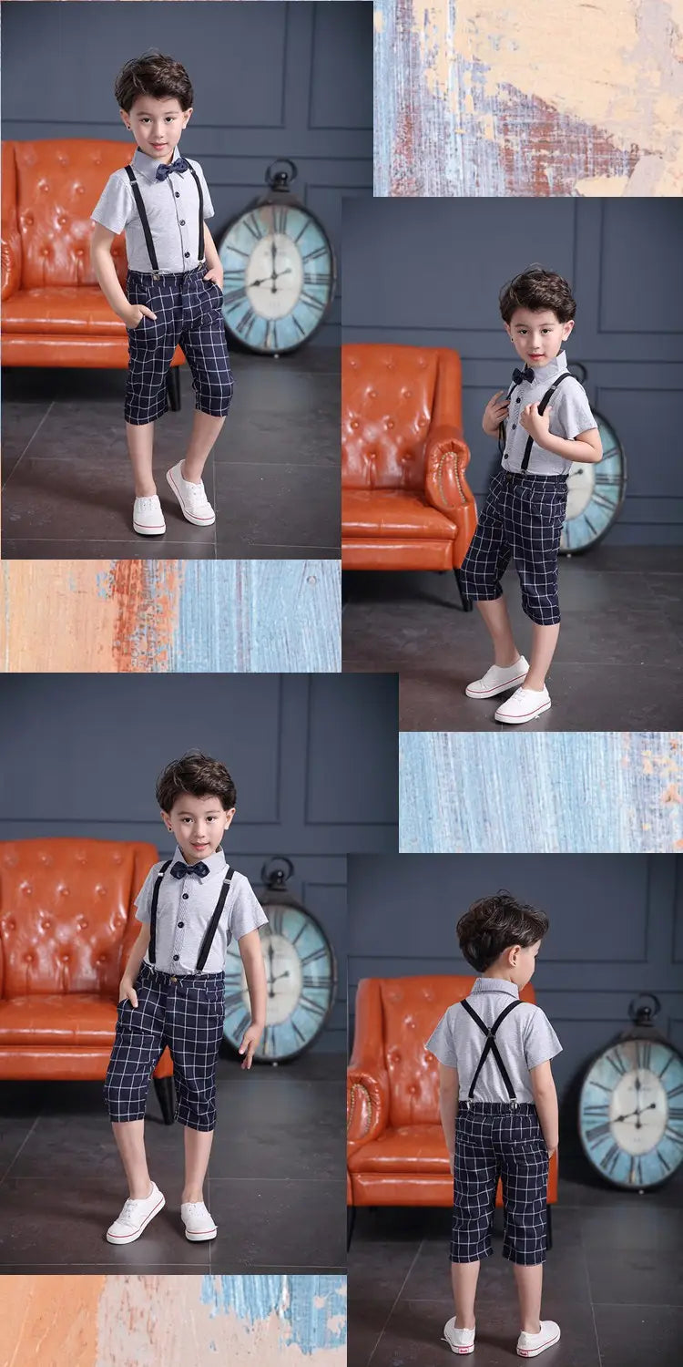 A young boy wearing a men’s plaid suspenders treasure suit tide suit featuring a white short-sleeved shirt with black suspenders and dark blue plaid shorts.