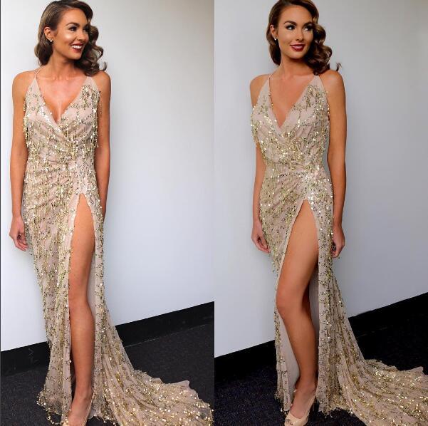 A shimmering gold halter strap sequin dress featuring a deep v neckline and high slit.