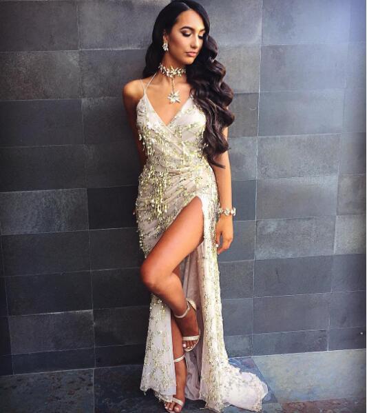a shimmering gold halter strap sequin dress featuring a plunging v neck and a high slit, perfect as a sexy halter strap evening gown