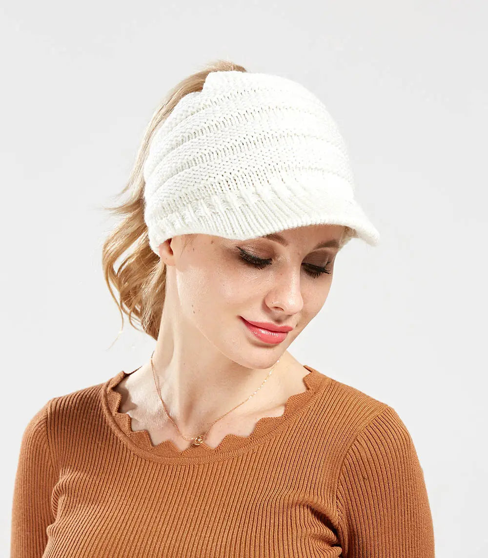 white knitted women ponytail beanie with a structured brim and ribbed texture suitable for beanies autumn winter wear