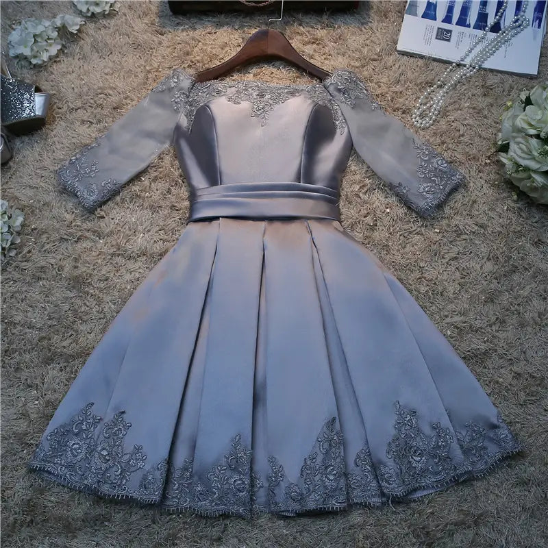 silver satin evening dress bride with three-quarter length sheer sleeves and intricate lace detailing along the neckline, cuffs, and hemline for bride wedding toast events