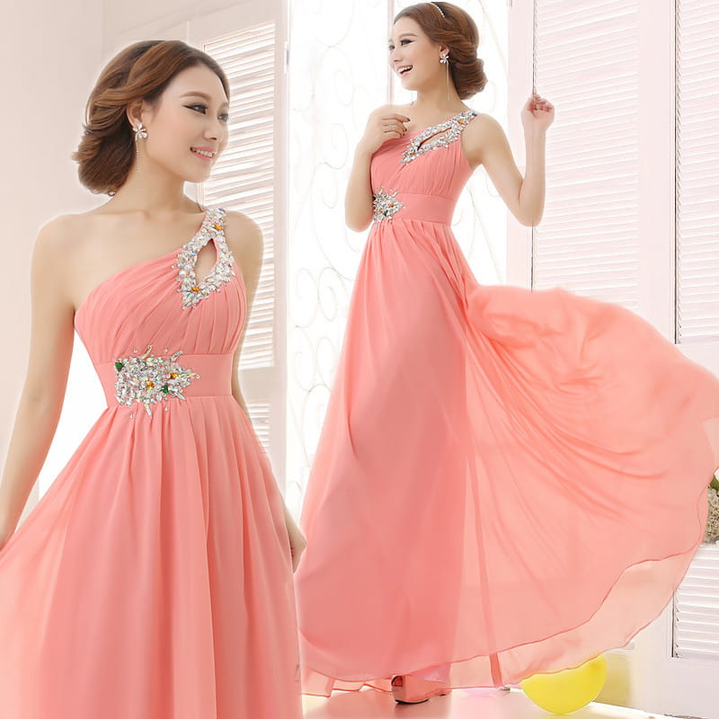 A flowing coral pink chiffon evening dress with sparkling beaded embellishments at the shoulder and waist suitable for dinner banquet long events.