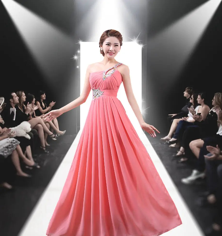 a flowing coral pink satin evening dress with a one-shoulder design and sparkling silver embellishments at the neckline and waist, ideal for dinner banquet long events